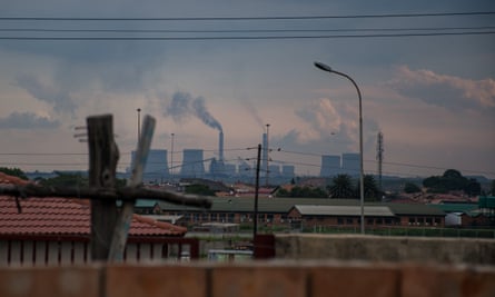 A view of a coal-fired power station from the town of Phola